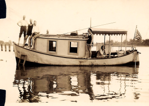 Olin (far left) and Mabel (seated under the awning) on their boat with friends, Willamette River, 1929