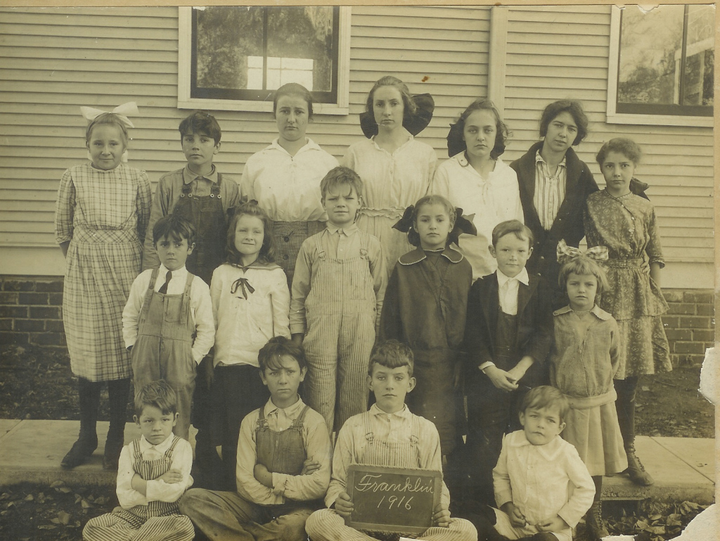 The Whitelaw children at the one-room Franklin School, Lawrence, Kansas, 1916. John, my father, is seated at the far left. His sister, Eleanor, is in the second row, second from left, and his brother, Neill, is on her left.