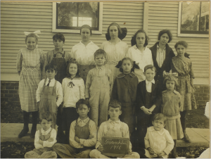 Franklin School, near Lawrence, Kansas, 1916. John is seated at lower left. Eleanor and Neill are in the second row, second and third from left.